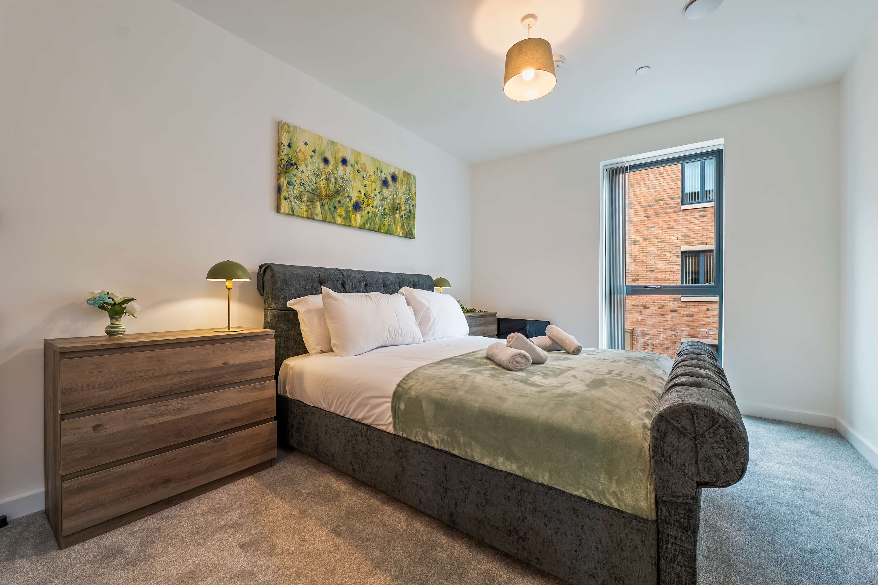 Hotel-grade styled bedroom with fresh linens and folded towels at a real Havanex-managed property